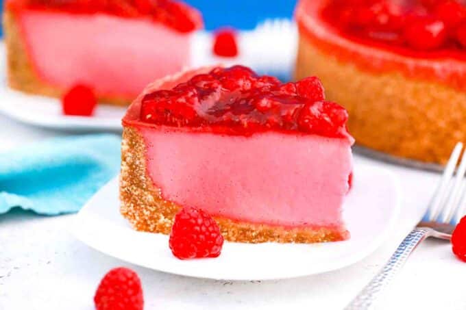 a slice of baked raspberry cheesecake on a serving plate