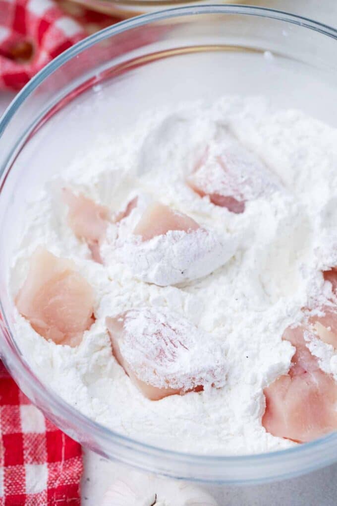 tossing chicken pieces in flour and cornstarch mixture