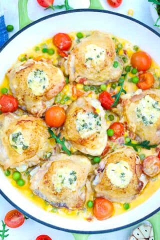 chicken thighs in a creamy sauce topped with herbed butter