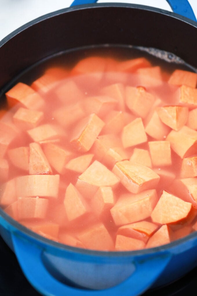 Boiling sweet potato chunks.