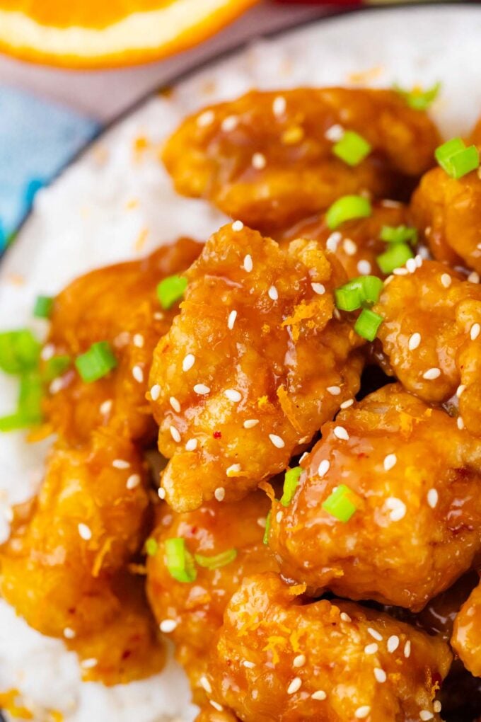 Chinese crispy orange chicken on top of white rice.