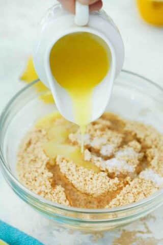 adding butter to cookie crumbs