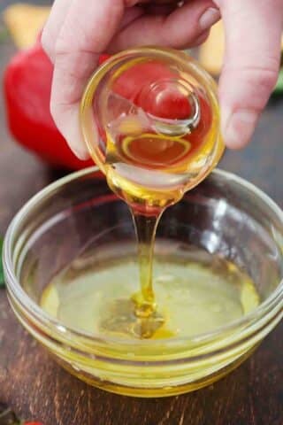 adding honey to salad dressing mixture
