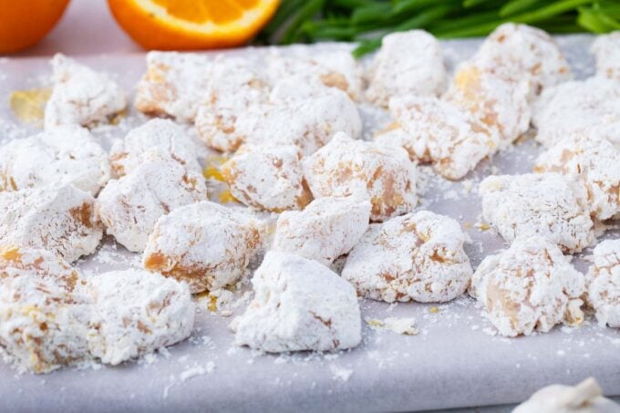 Chicken pieces drenched in egg and tossed in cornstarch mixture.