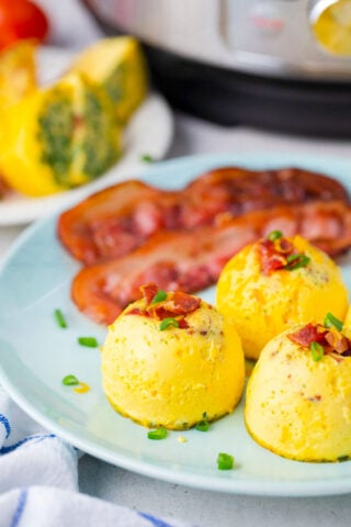 Instant Pot egg bites served with crispy bacon.