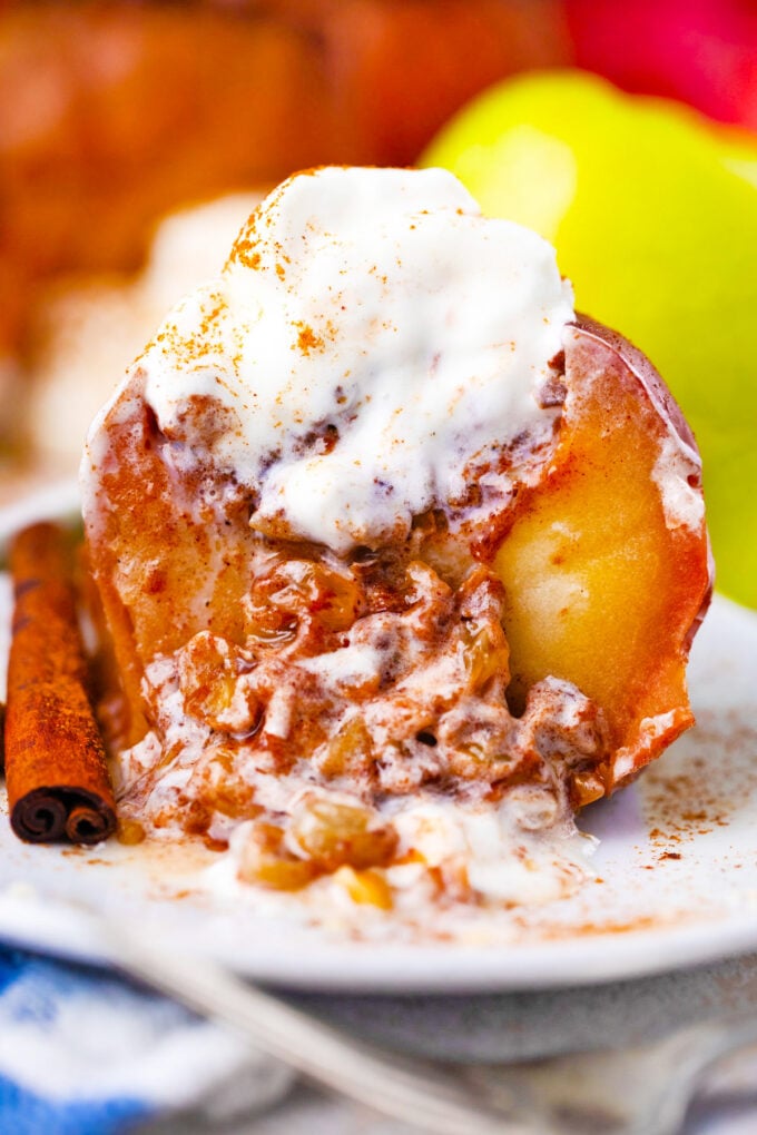 Sliced instant pot baked apple topped with ice cream.