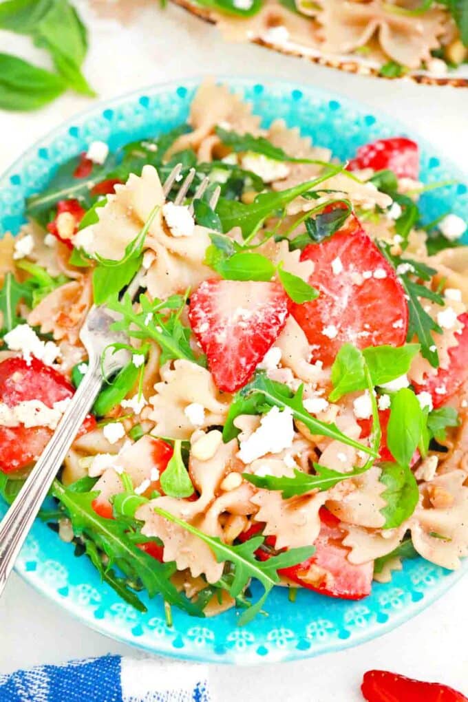 overhead shot of strawberry balsamic pasta salad with arugula