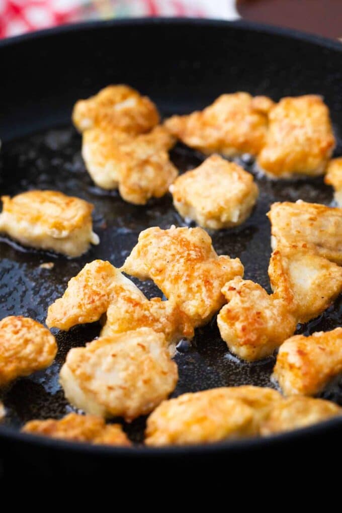 fired crispy chicken pieces in a pan with oil