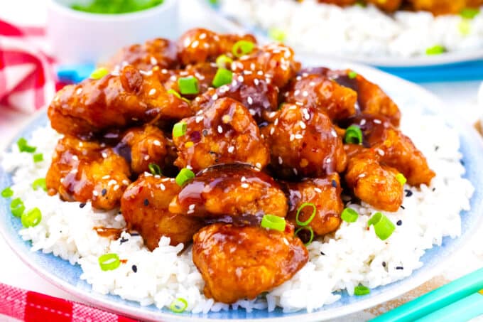 Homemade General Tso's chicken pieces over white rice.