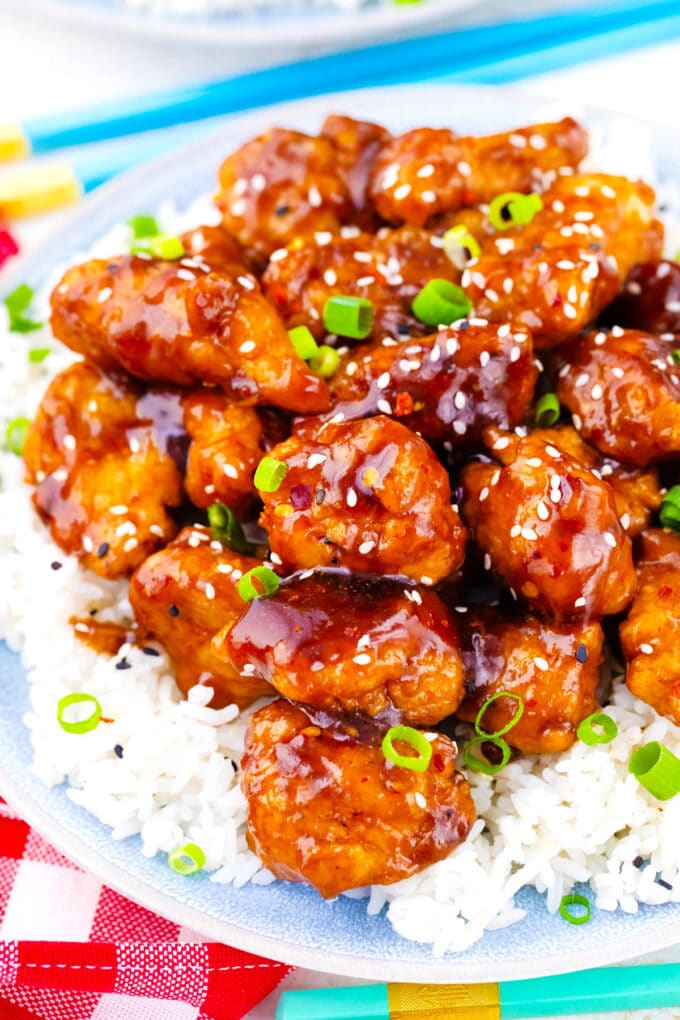 Crispy and sticky General Tso's chicken pieces over white rice.