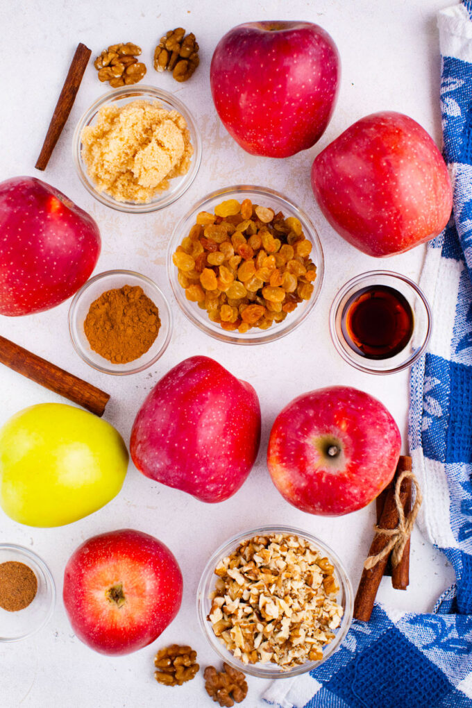 Overhead shot of Instant Pot baked apples ingredients arranged on a white surface.