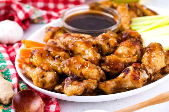 Serving instant pot chicken wings with veggies and honey garlic ginger sauce.