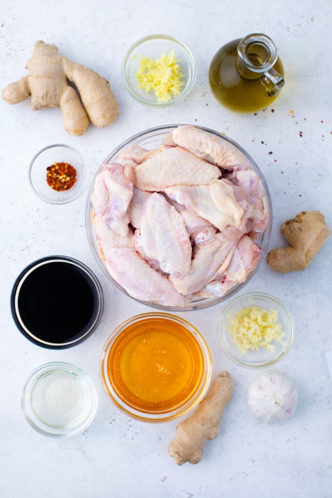 Overhead shot of instant pot chicken wings ingredients arranged on a light surface.