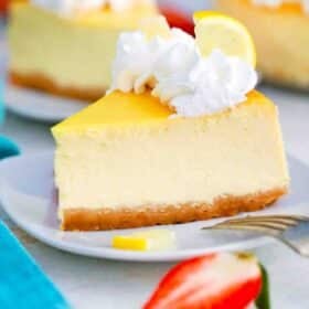 close shot of a slice of lemon ricotta cheesecake topped with whipped cream