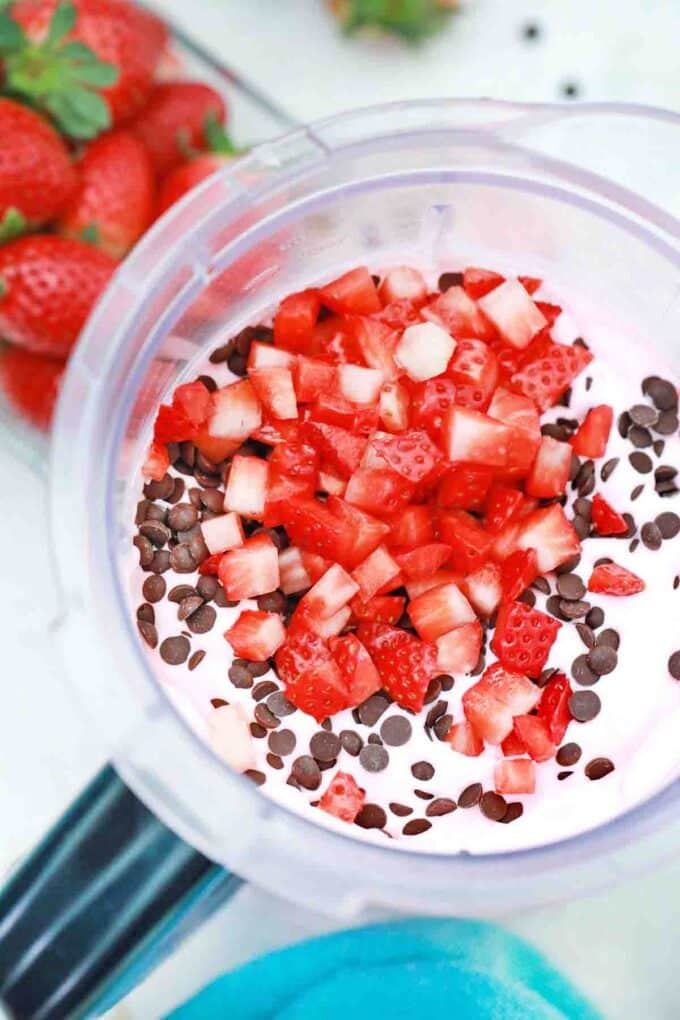 stirring chocolate chips and strawberries