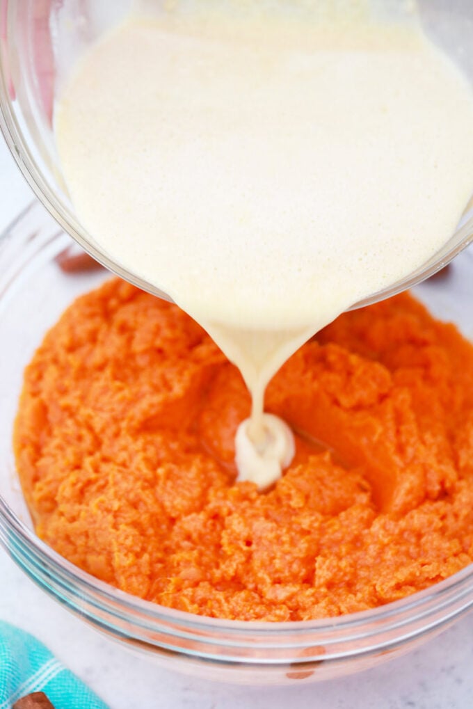 Adding cream to mashed potatoes.