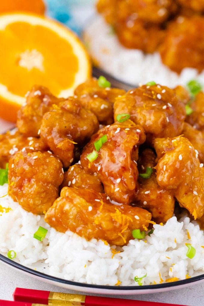 Crispy orange chicken bites on top of rice.