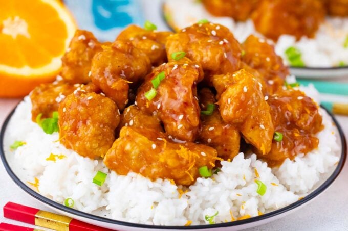 A pile of crispy orange chicken served with rice.
