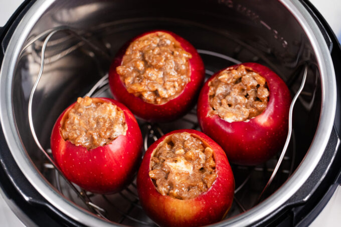 Stuffed apples arranged on a trivet in the Instant pot.