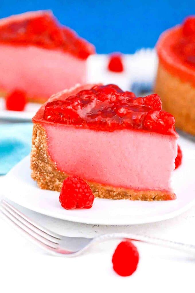 raspberry cheesecake topped with homemade raspberry sauce