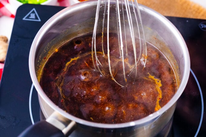 Simmering General Tso sauce in a saucepan.