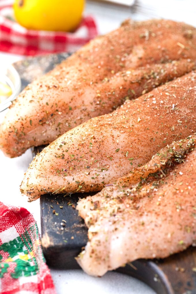 Seasoning chicken breats.