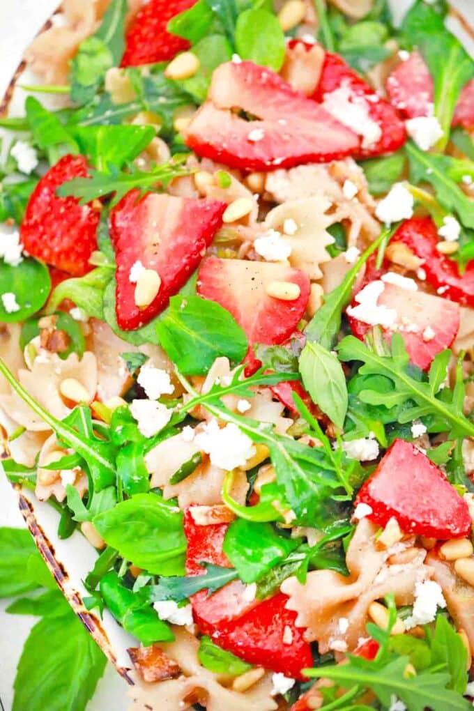 a serving plate of strawberry balsamic pasta salad