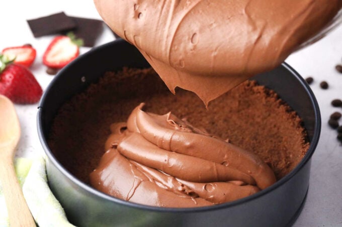 Transferring Godiva chocolate batter into a chocolate crust.