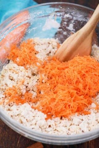 adding freshly grated carrots to dough mixture