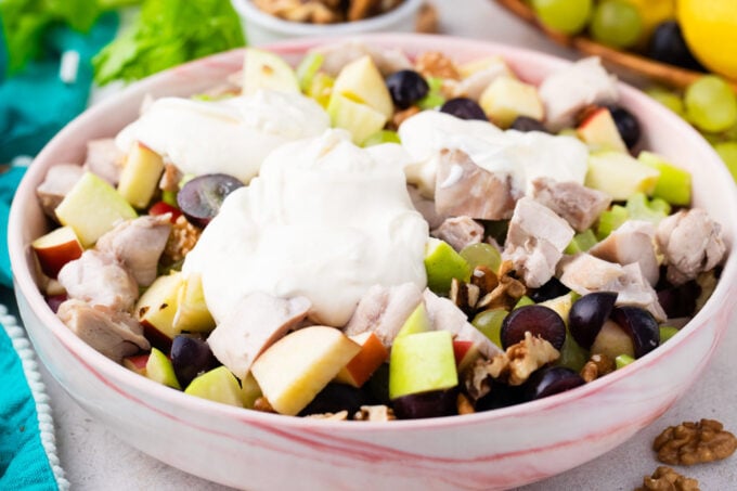 Adding dressing to chicken Waldorf salad.