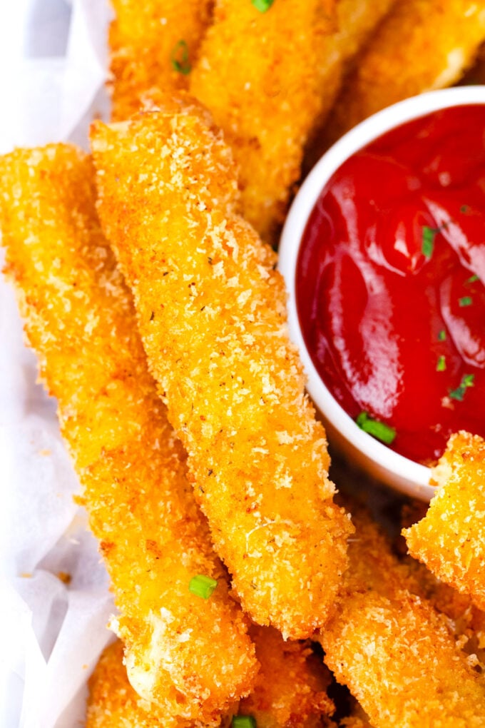 Golden brown crispy fried cheese sticks.