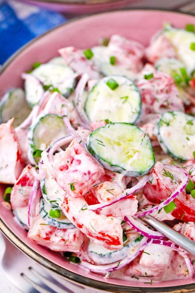 Creamy cucumber tomato salad with Greek yogurt dressing.