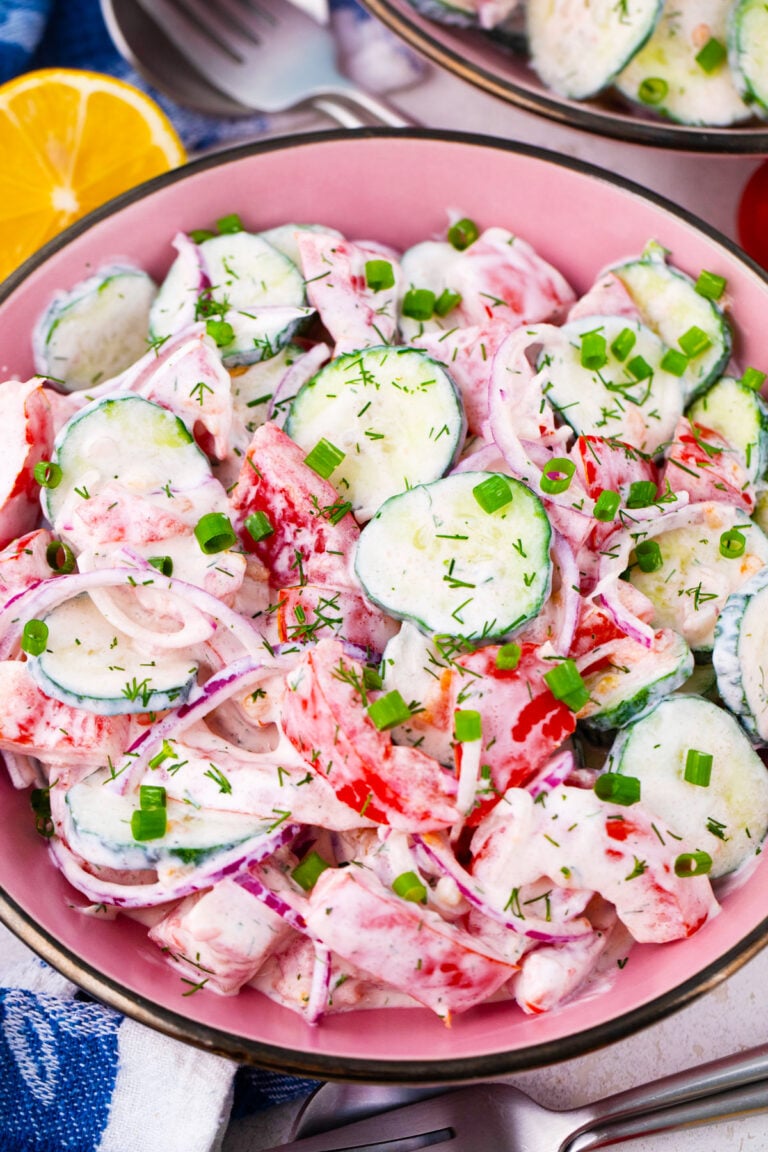 Creamy cucumber tomato salad with red onion.