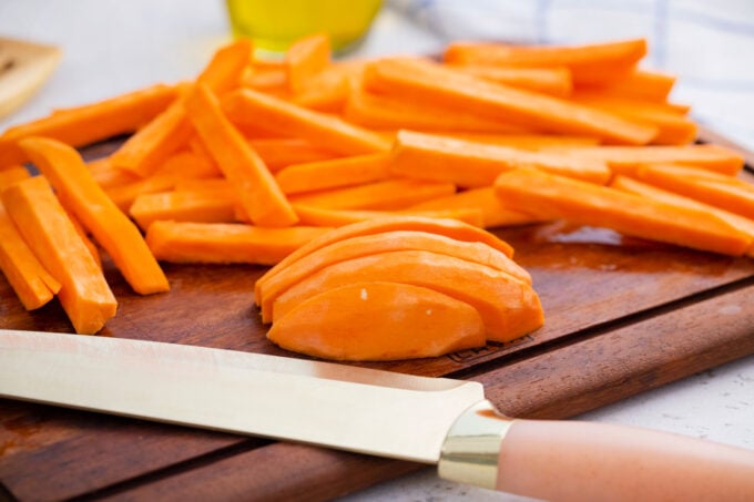 Cutting sweet potatoes into fries.