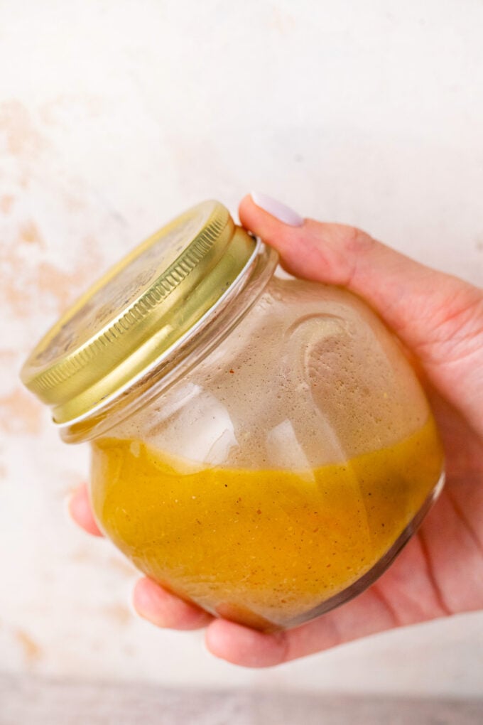A jar of homemade Greek salad dressing.