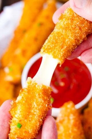 Pulling a crispy fried cheese stick.