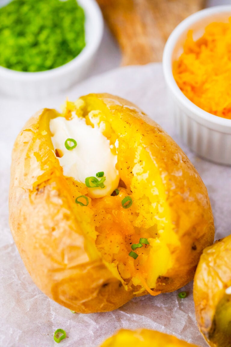 Cheesy microwaved potato topped with sour cream and chives.