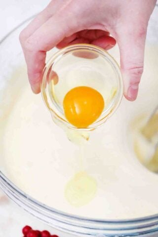 adding eggs to cheesecake batter