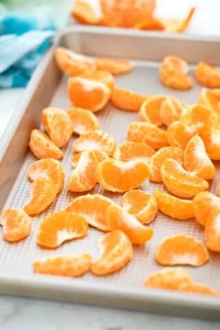 tangerine slices on a baking sheet