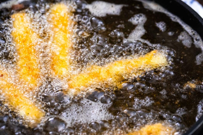 Frying cheese sticks.