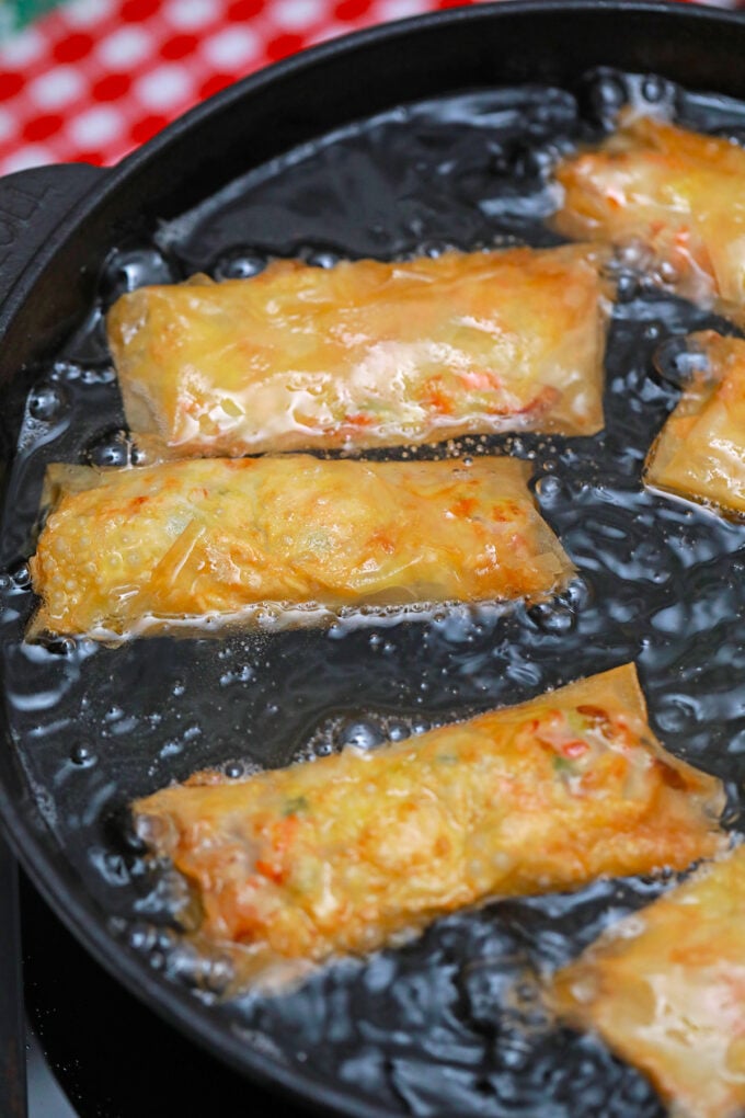Frying Panda Express chicken egg rolls in oil.