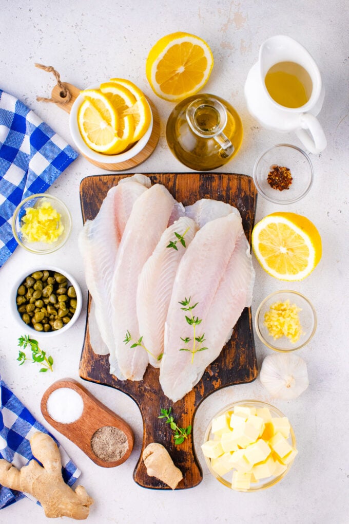 Lemon garlic butter swai fish ingredients arranged on a white surface.