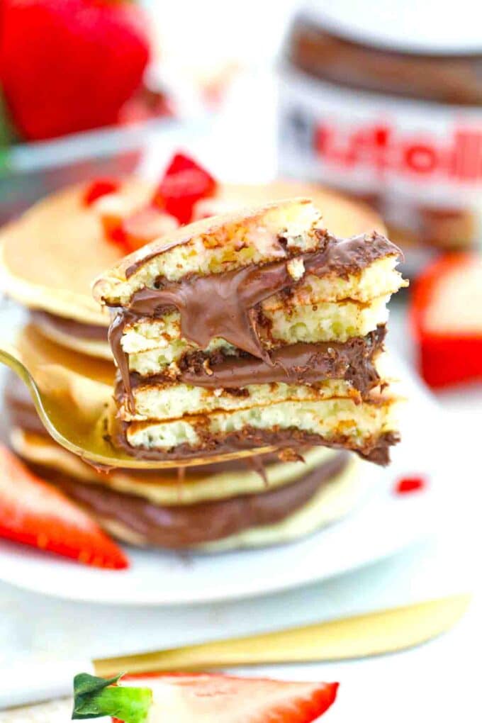 a bite of a stack of Nutella pancakes