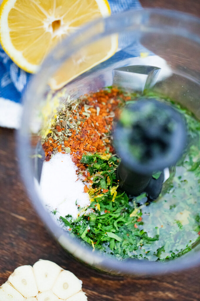 Lemon chimichurri sauce ingredients in a food processor.