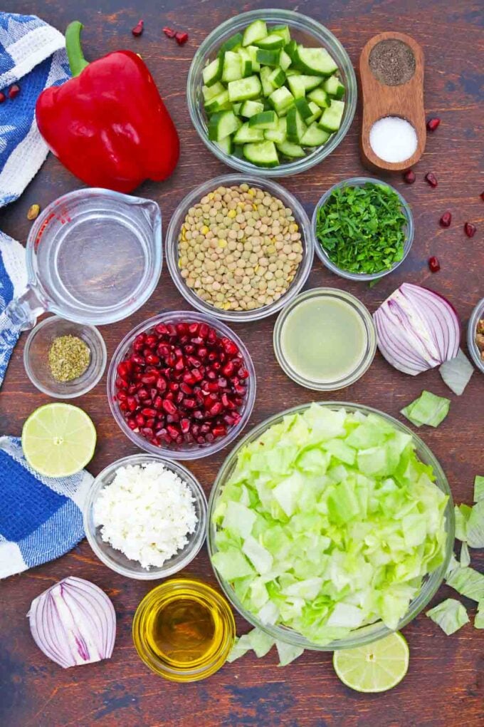 overhead shot of mediterranean lentil salad ingredients in bowls on a table