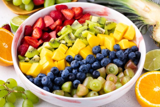 Assembling fruit salad.