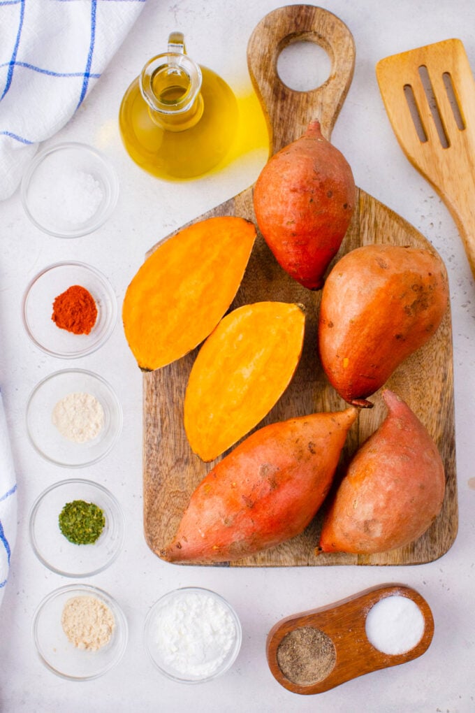 Overhead shot of oven roasted sweet potato fries ingredients on a white table.