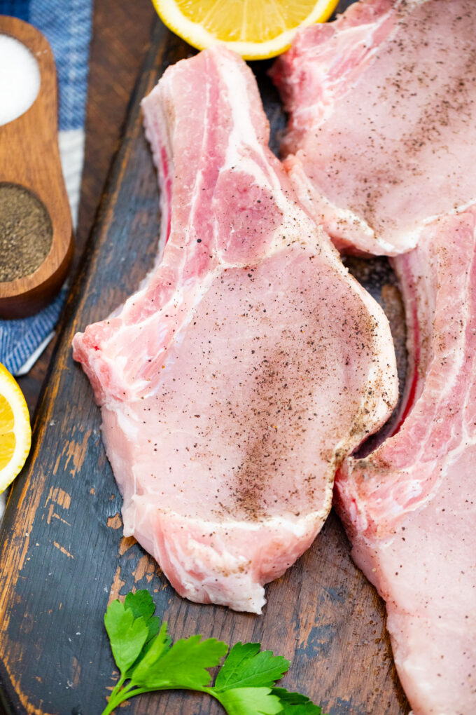 Seasoning pork chops.
