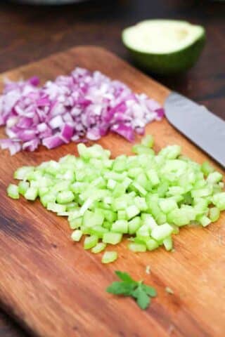 chopped red onion and celery on a cutting board