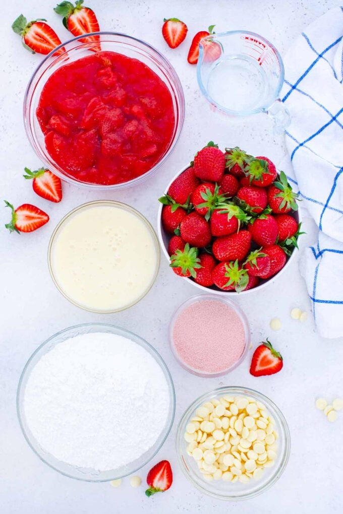 overhead shot of strawberry poke cake ingredients in bowls on a table